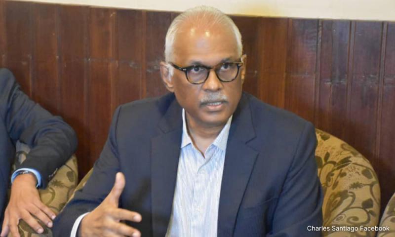 Charles Santiago gesturing as he speaks during a press interview